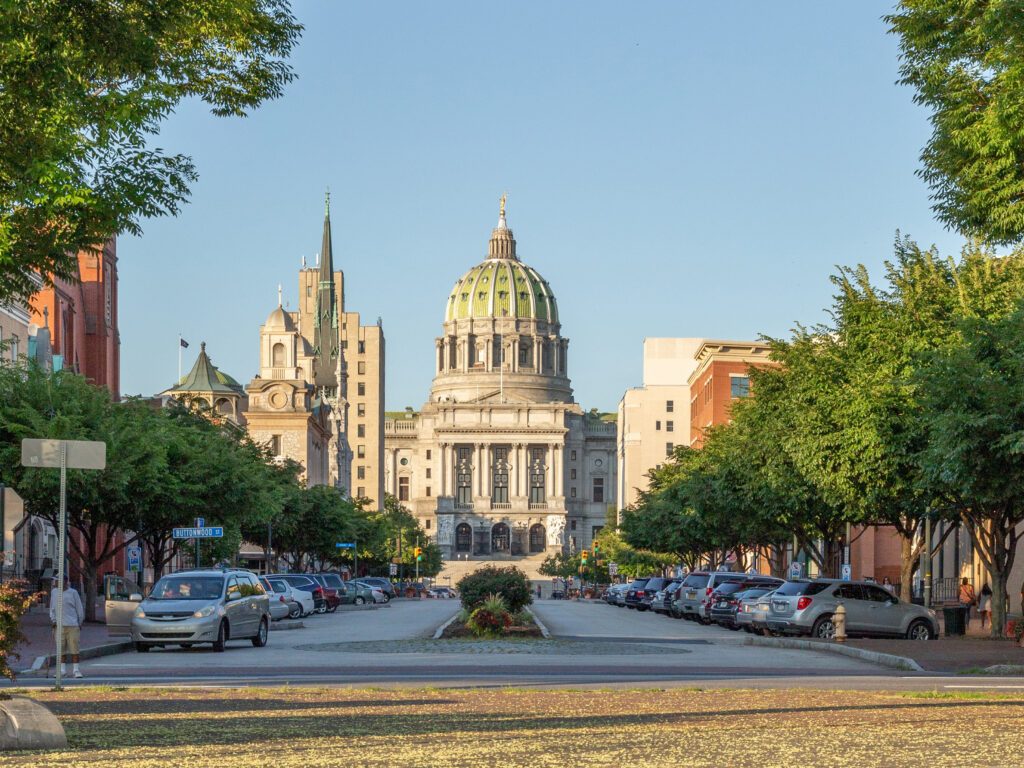 View of downtown Harrisburg, PA and the Pennsylvania State Capitol building — representing local dog poop cleanup and pet waste removal services available to residents and businesses in the Harrisburg area.