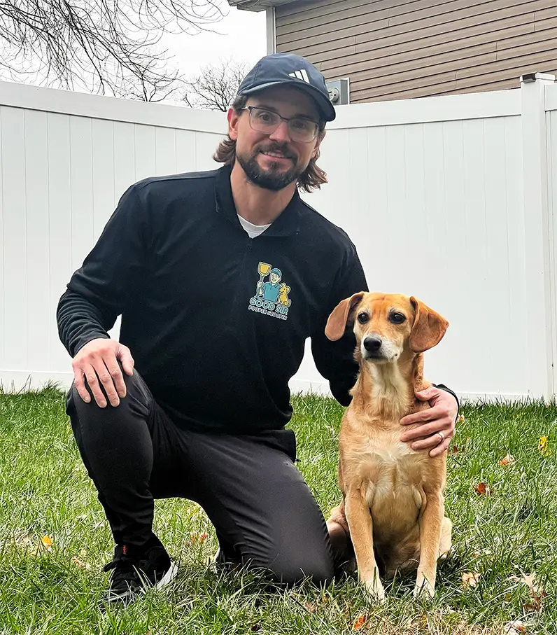 “Pet waste removal professional from Good Sir Pooper Scooper kneeling in a backyard with a dog, representing reliable dog poop cleanup services in Harrisburg, PA, serving both Dauphin County and Cumberland County.”